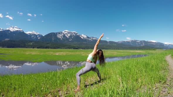 Woman practicing yoga in the grassland