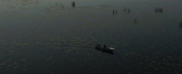 A Man Is Floating on a River on a Boat