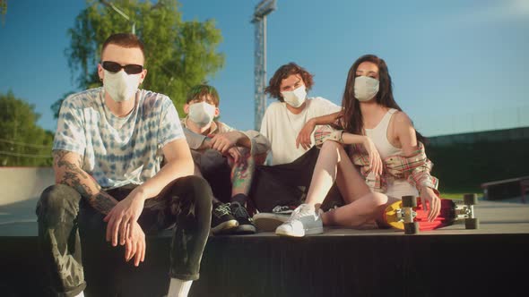 Group of Happy Friends Having Fun in Skatepark Skaters Wearing Protection Coronavirus Covid 19