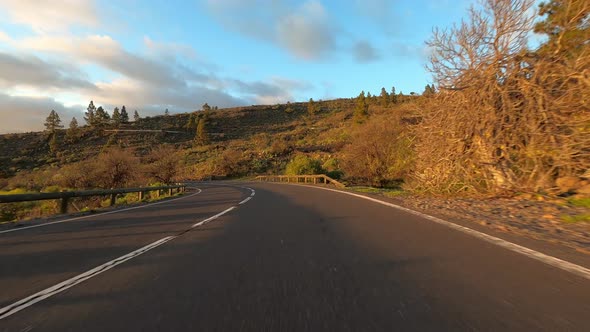 Long asphalt road ground view with sunset light and travel concept - mountain and sky