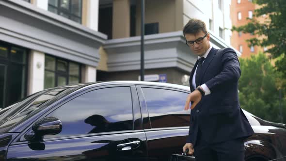 Happy Manager Arriving at Work in Time by New Expensive Car