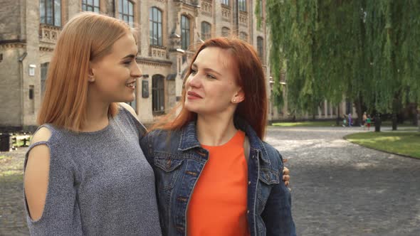 Two Girls Laughing and Hugging