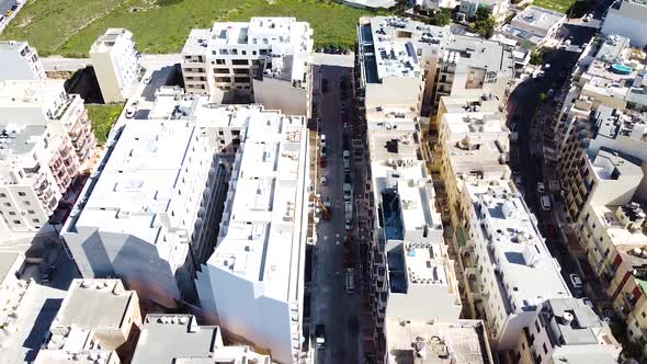 Narrow street in residential area of St. Paul Bay in Malta island, aerial view