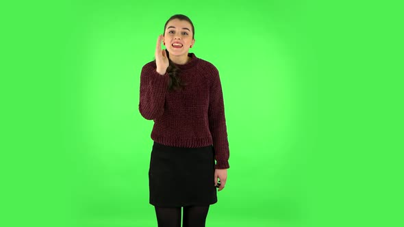 Girl Screams Calling Someone on a Green Screen at Studio. Green Screen