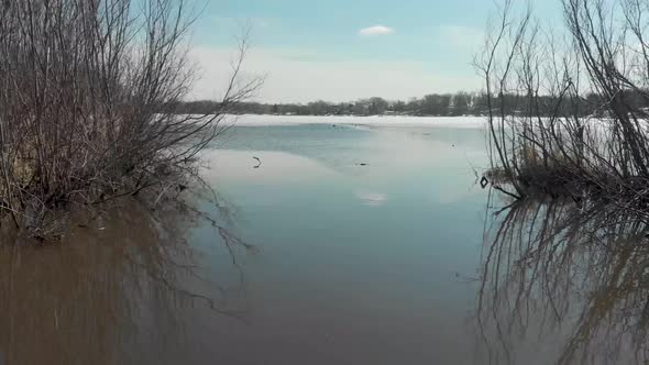 Aerial Drone video from Lake Susan in Chanhassen Minnesota flying through a narrow creek out into th