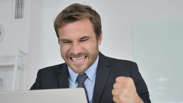 Close Up of Businessman Celebrating Success at Work