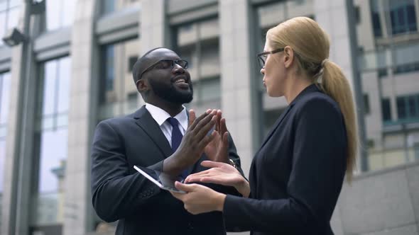 Businessman Convinces Investor of Project Profitability, Shows Income on Tablet