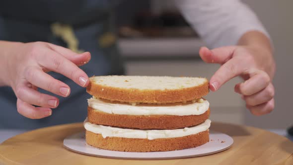 The Pastry Chef Puts the Third Layer of Sponge Cake