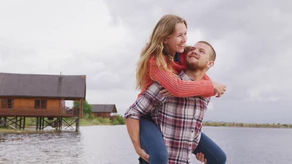 Caucasian couple having a good time on a trip to the mountains, smiling, the man holding the woman