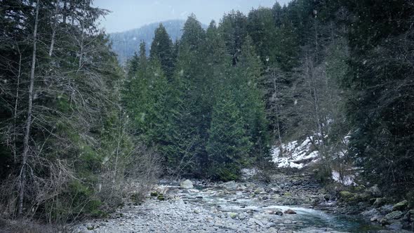 Snow Falls On Wild River Landscape