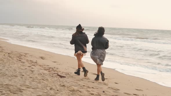 Two Woman Run Along the Sea Beach