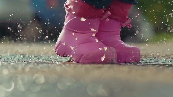 Child in Pink Rubber Waterproof Boots