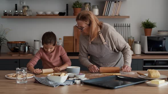 Caucasian girl preparing homemade cookies with grandmother. Shot with RED helium camera in 8K