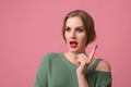 young attractive woman in green sweater, pink background - PhotoDune Item for Sale