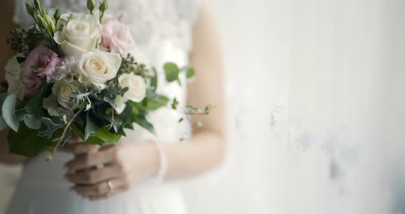 Bride Holding Flowers in Hands