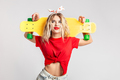 Young girl dressed in short denim shorts and a red t-shirt poses with a yellow skateboard in the - PhotoDune Item for Sale