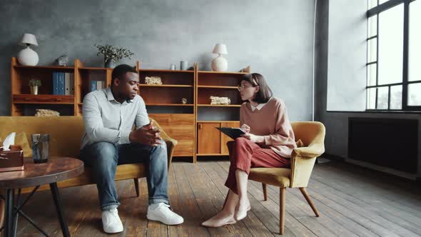 Afro-American Man Speaking with Female Counseling Psychologist