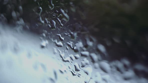 drops of water on the window. camera movement along wet glass on a rainy day