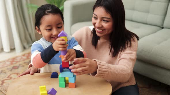 Latin Mother and Kid Having Fun Playing Didactic Games at Home  Family Time Together