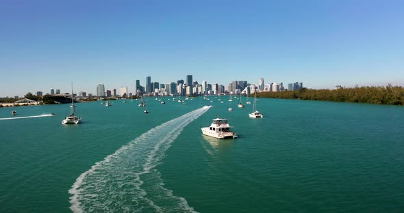 4K aerial of Miami bay with downtown Miami in background. Drone flying over yachts in Miami 