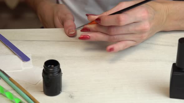 Self Manicure at Home Applying a Base Coat Before Coating Nails with Nail Polish