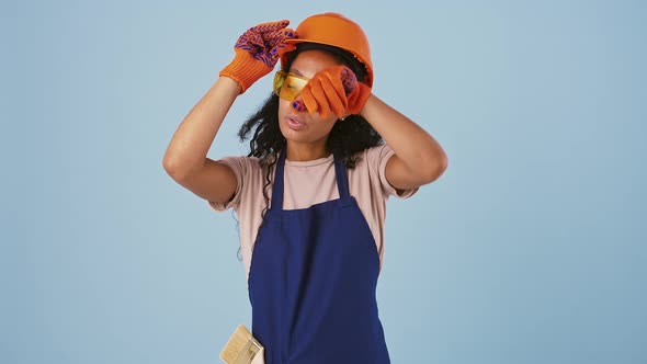 Ethnic Black Female Worker in Hard Hat Protective Goggles and Gloves