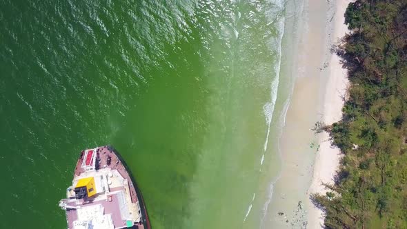 Vertical Aerial View Sea Washes Tanker Grounded on Beach