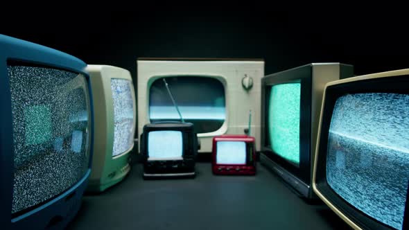 Old Televisions with Grey Interference Screen on Black Background