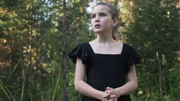 Scared Girl Looks Around Dark Forest Dreaming for Help