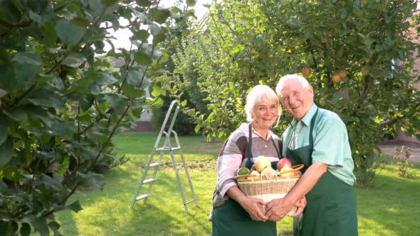 Couple Holding Basket and Laughing.