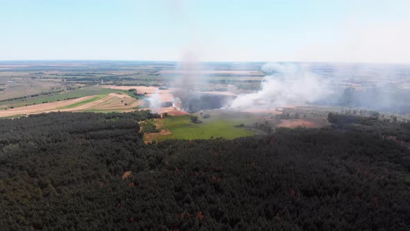 Aerial View of Fire in Wheat Field. Flying Over Smoke Above Agricultural Fields