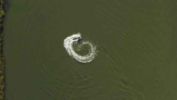 Overhead view of someone jet skiing and doing doughnuts in the Delta in Antioch Northern California