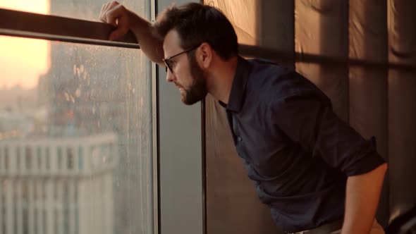 Man In Office.Businessman Staying Near Windows.Businessman Stand Near The Panoramic Window.