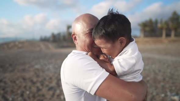 Happy Asian Bald Man Talking to Cute Boy Kissing Grandfather in Slow Motion