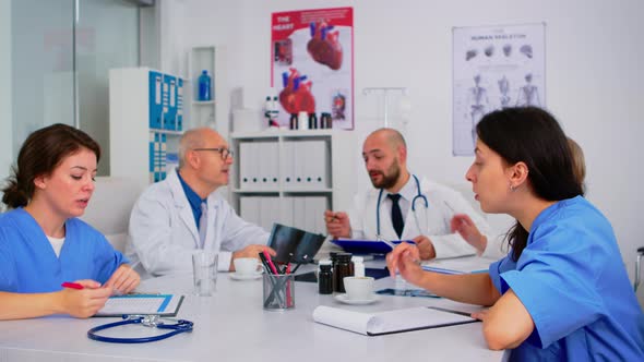 Medical Nurses Having Meeting with Doctors in White Lab Coats