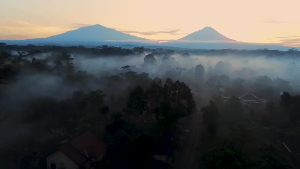 Magical misty morning in tropical forest of Windusari, Indonesia, aerial view