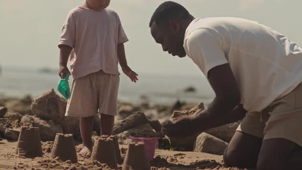 Father and Son Building Sand Castles