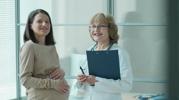Portrait of Pregnant Woman and Doctor in Clinic