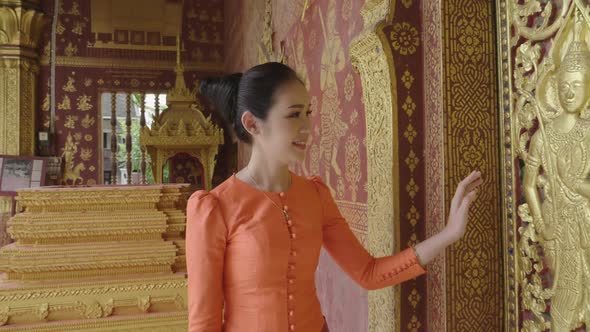 Beautiful Asian Girl Wearing Traditional Dress Touching Ancient Buddhist Temple Mural Painting