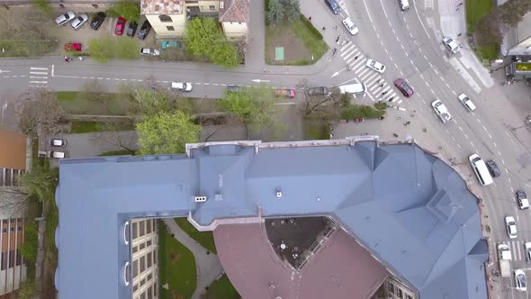 Top down aerial perspective following street traffic in the old city of Cluj in Romania above the bu