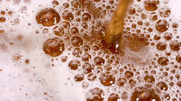 Top View of Light Beer Being Poured Into a Glass