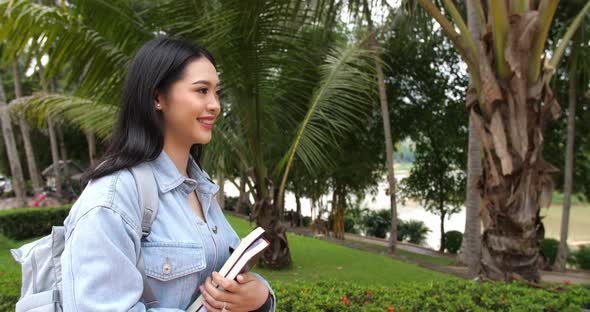 Asian Woman Student Walking In The Park