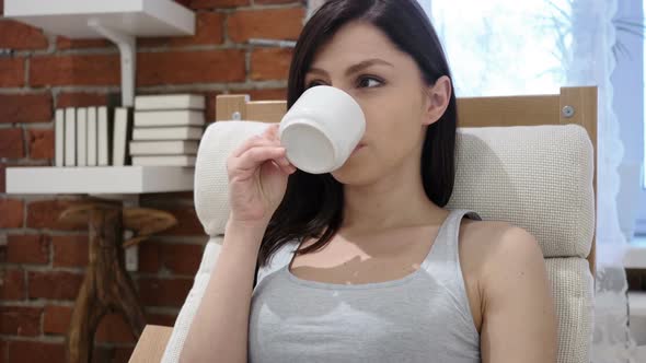 Portrait of Young Woman Drinking Coffee From Cup