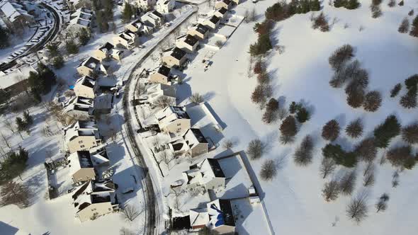 Aerial Top View of Snow Covered House Parked Cars Trees in Frosty Winter Weather Time