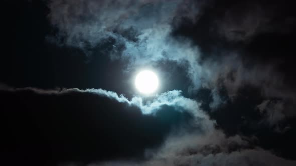 Timelapse Full Moon on Dark Cloudy Sky