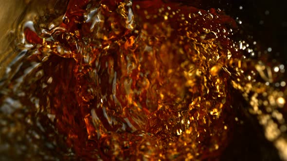 Super Slow Motion Abstract Shot of Pouring Brown Liquid in Glass Bottle at 1000 Fps