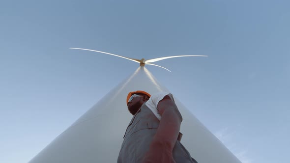 Smiling Engineer Near Wind Turbines Develop Ecological Energy Gesturing Thumb Up