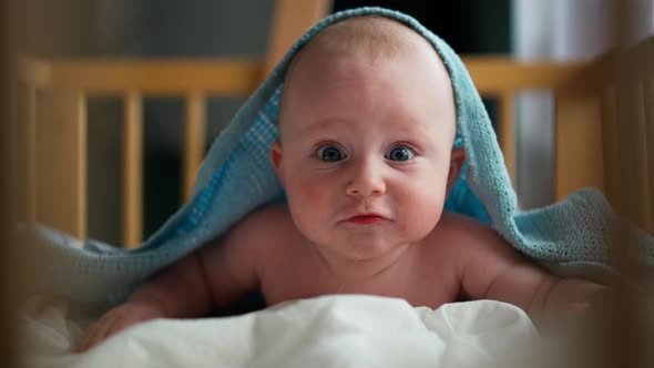 Adorable Baby Smiling and Lying on Bed at Bedroom