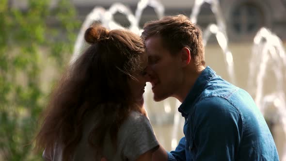 Close Up Couple Kissing on the Background of Fountain
