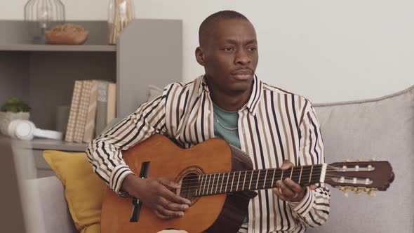 African Man Enjoying Playing Guitar